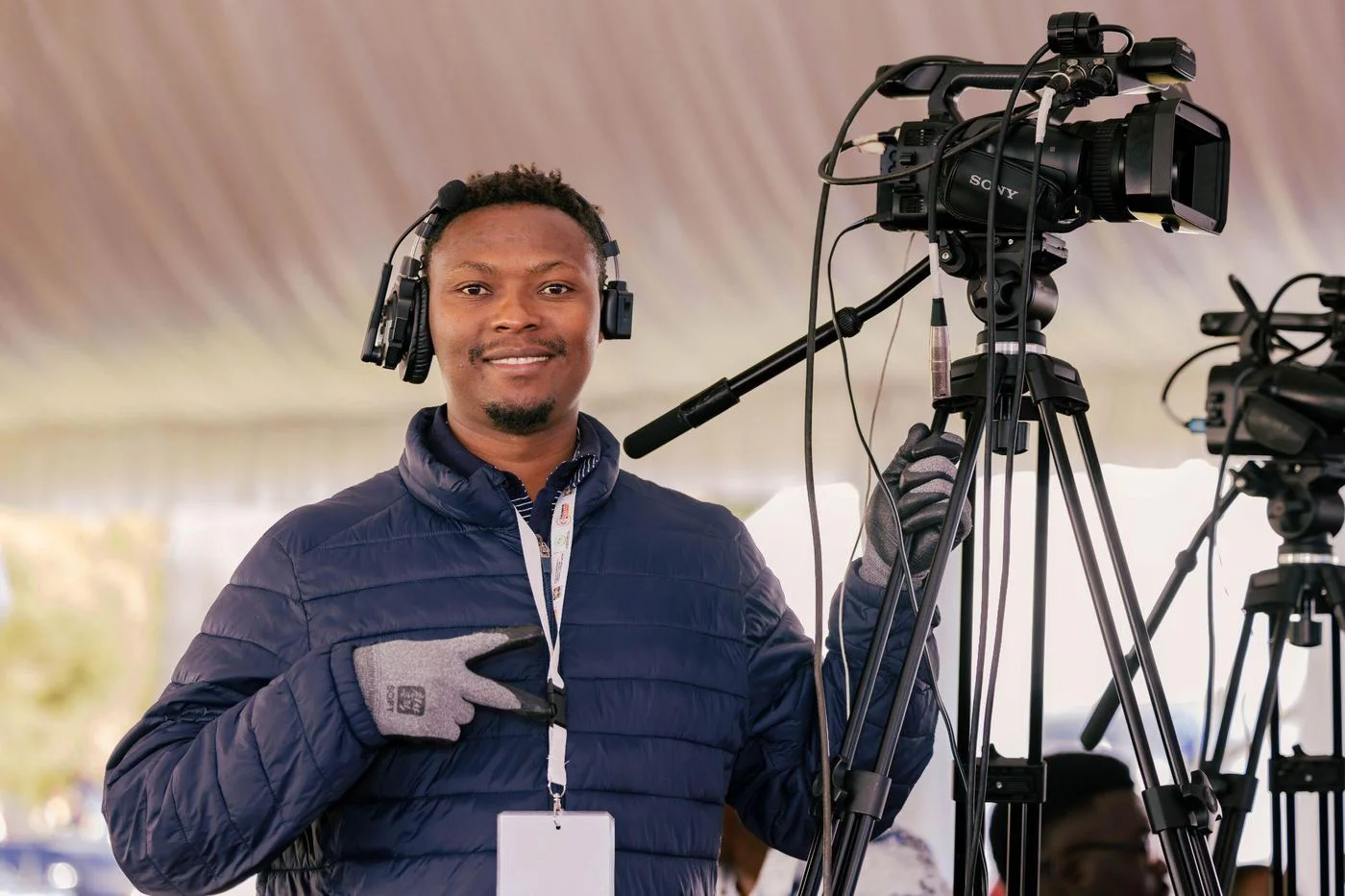 Two crew members with broadcast cameras